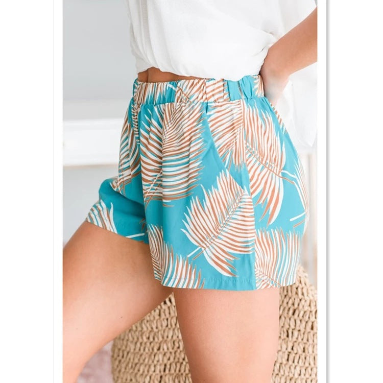 Women's breezy beach shorts with elastic waistband and tropical leaf design