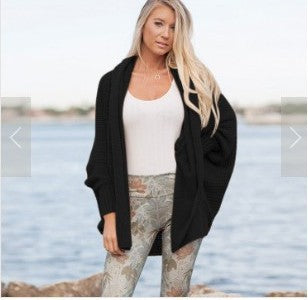 Women oversized knitted poncho with structured design and fringe details Lune London