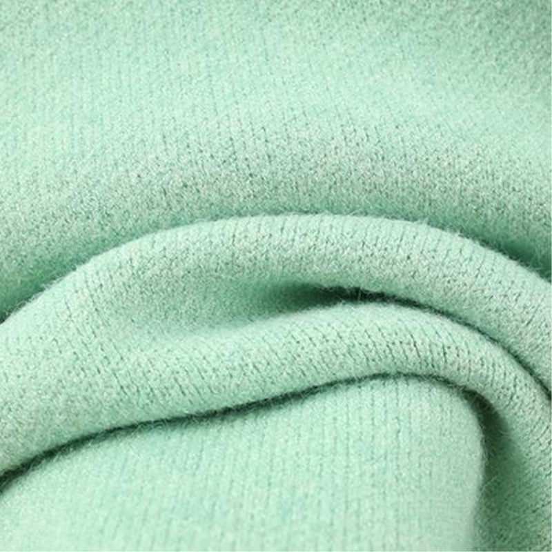 Women’s fashionable knitted set with a comfortable oversized sweater and a chic fitted dress.