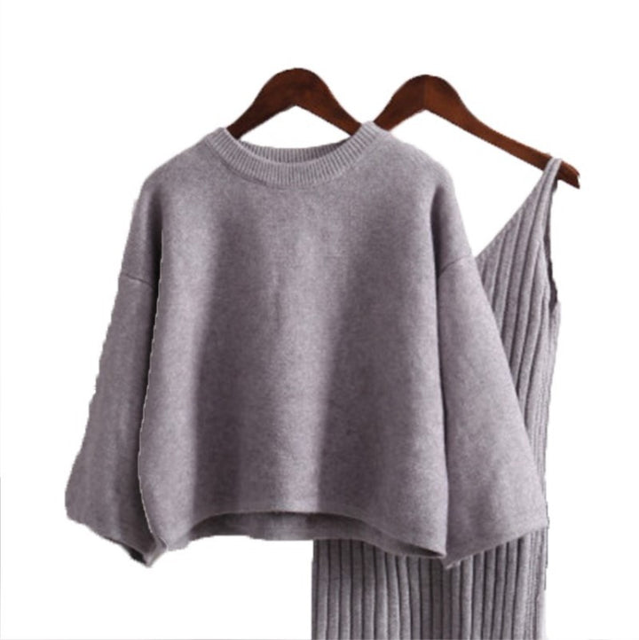 Women’s fashionable knitted set with a comfortable oversized sweater and a chic fitted dress.