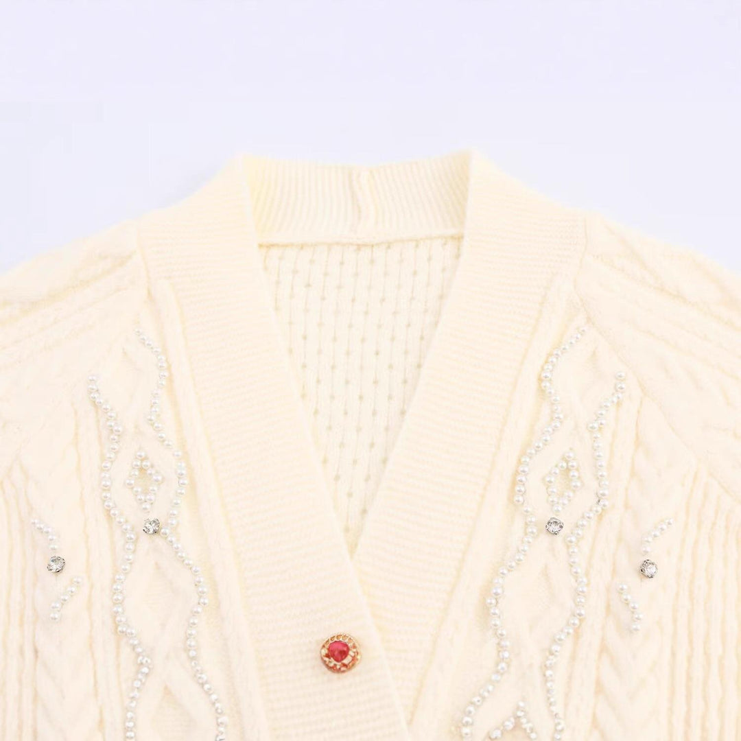 Elegant women's cardigan with decorative buttons and ruffle details Lune London
