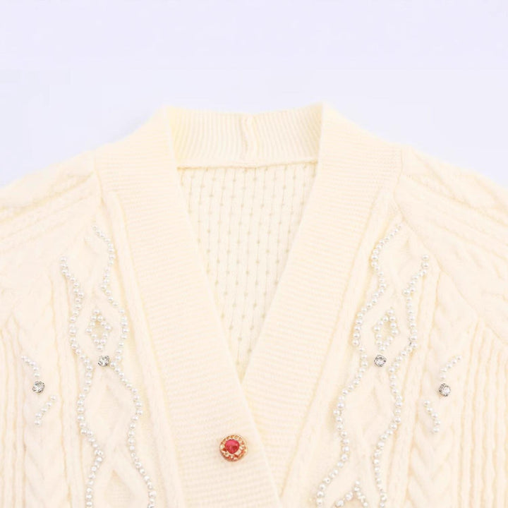 Elegant women's cardigan with decorative buttons and ruffle details Lune London