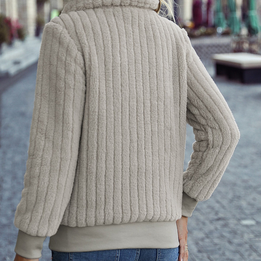 Fleece sweater for women with a high collar and side pockets. Lune London
