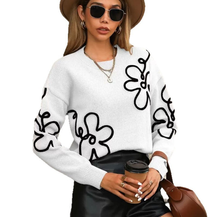 Pull féminin à la mode avec des appliqués floraux Chic & Stil