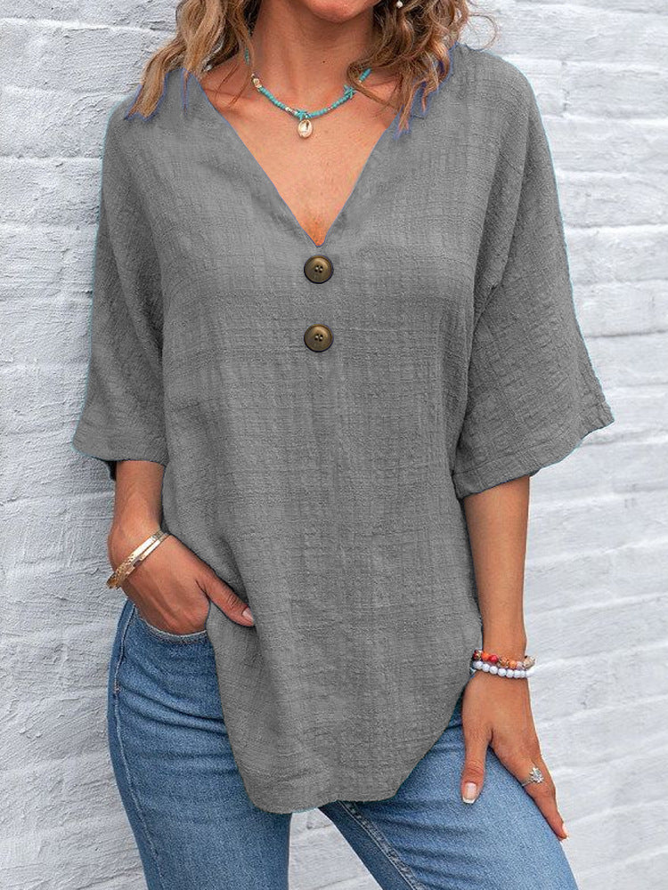Ladies' V-neck blouse with decorative buttons and chic casual cut