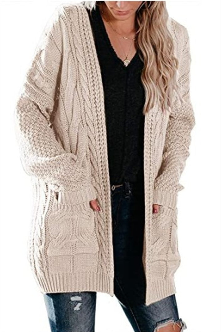 Ladies chunky knit cardigan with a striking cable structure and practical pockets Lune London