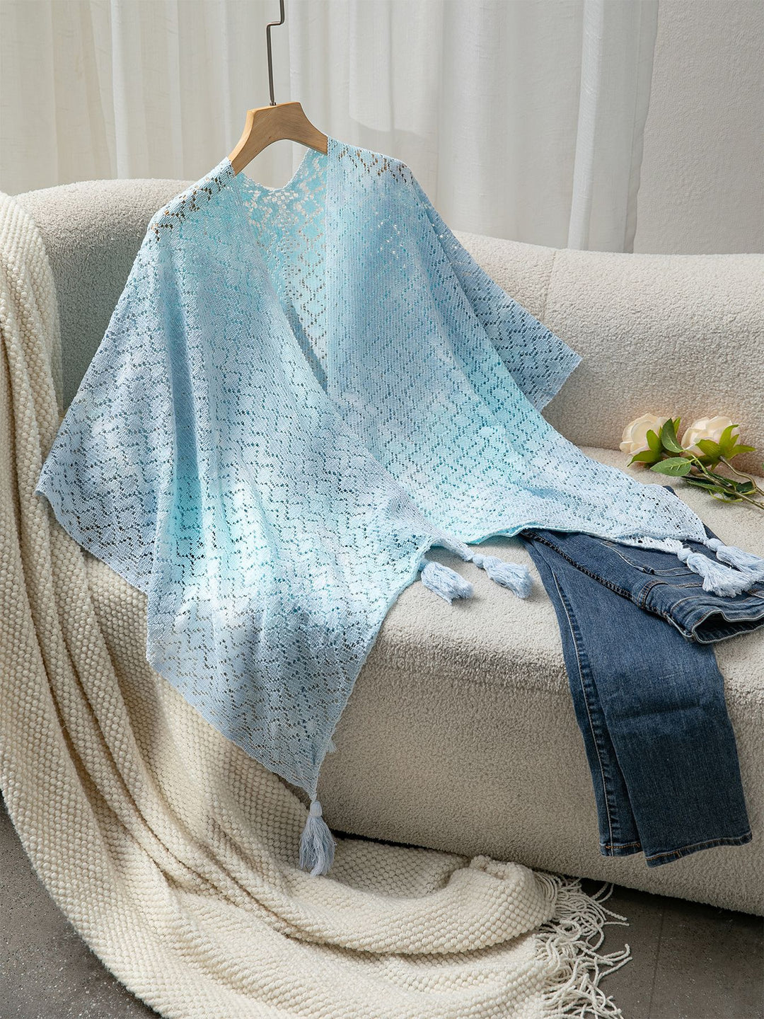 Airy knitted poncho for ladies with decorative fringes Lune London
