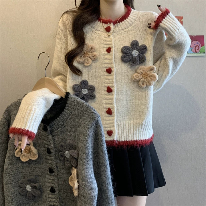 Ladies playful pullover with heart-shaped button closure and floral appliqués Lune London