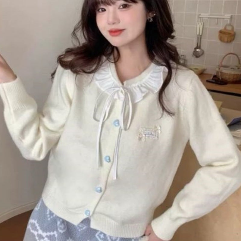 Ladies playful cardigan with ruffle detail and pearl-like buttons Lune London