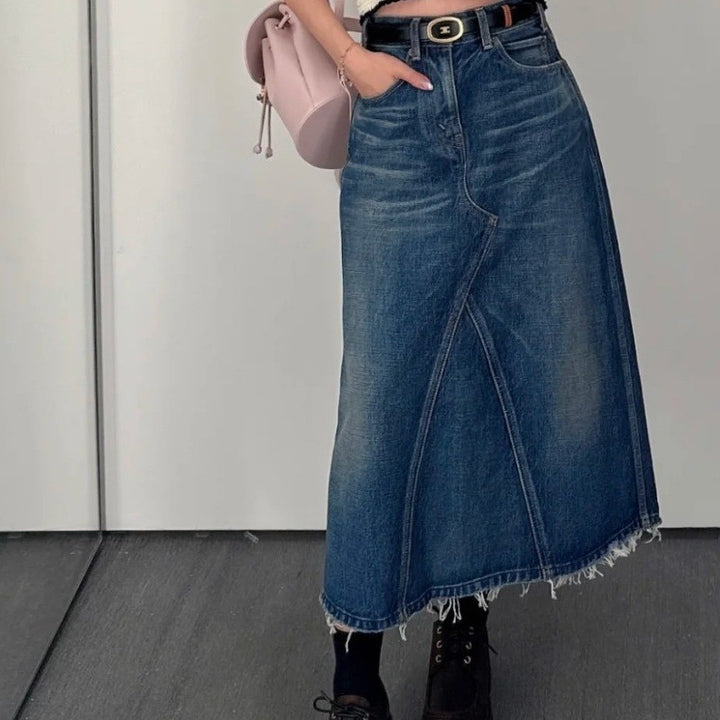 Women's maxi skirt in a casual denim style with asymmetrical hem and fringes Lune London