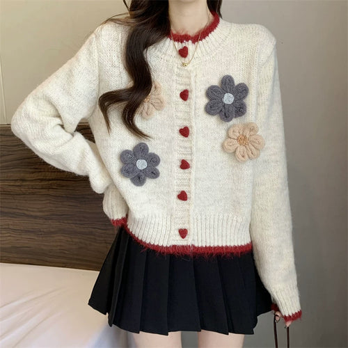 Ladies playful pullover with heart-shaped button closure and floral appliqués Lune London