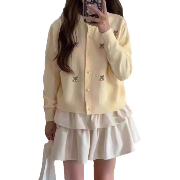 Women's knit jacket with a playful design and chic pearl buttons