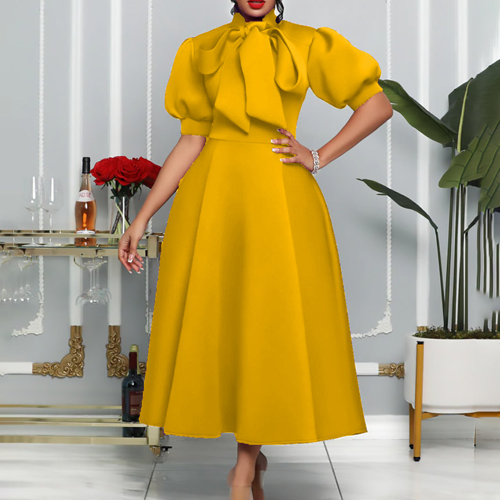 Elegant maxi dress for women with voluminous puff sleeves and a bow neckline Lune London
