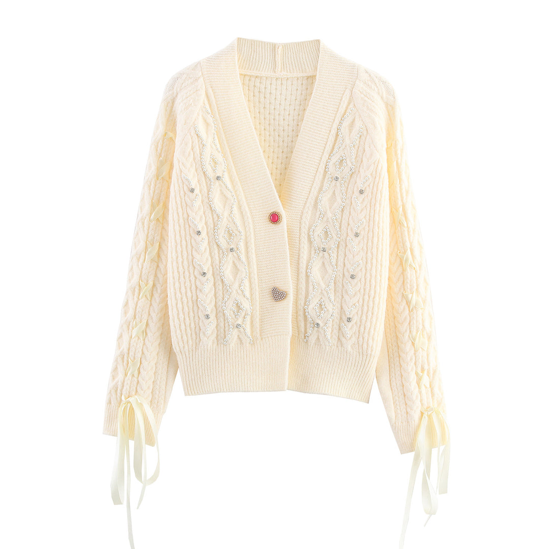 Knitted jacket for women with cable pattern and decorative button details Lune London