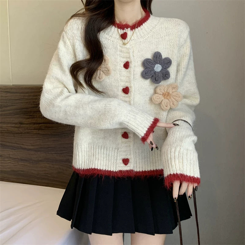 Ladies playful pullover with heart-shaped button closure and floral appliqués Lune London