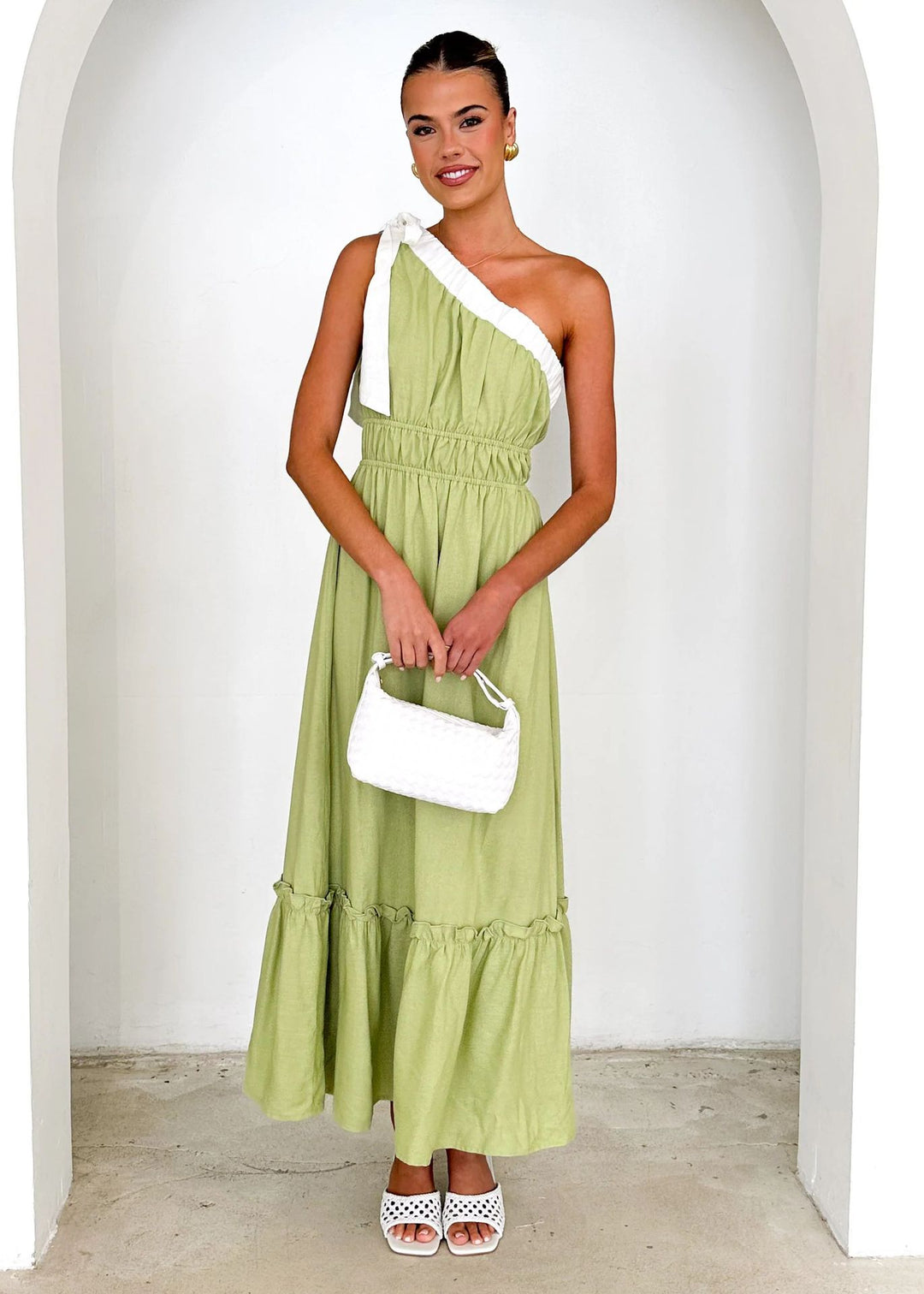 Women's maxi dress with asymmetrical shoulder design and flowing pleated skirt