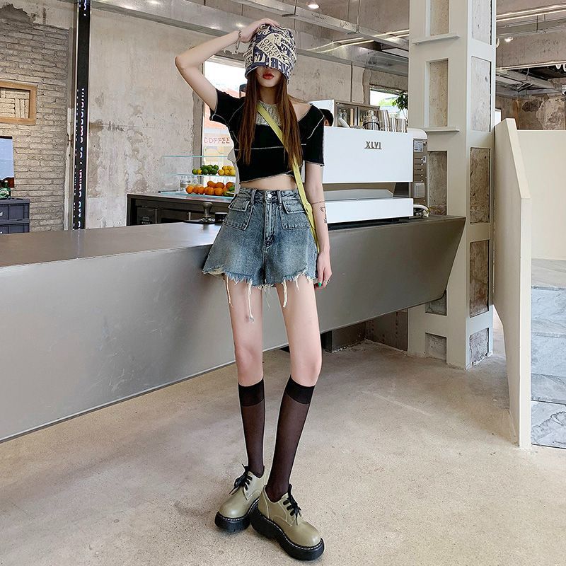 Women's denim shorts with frayed hems and unique embroidery detail Lune London