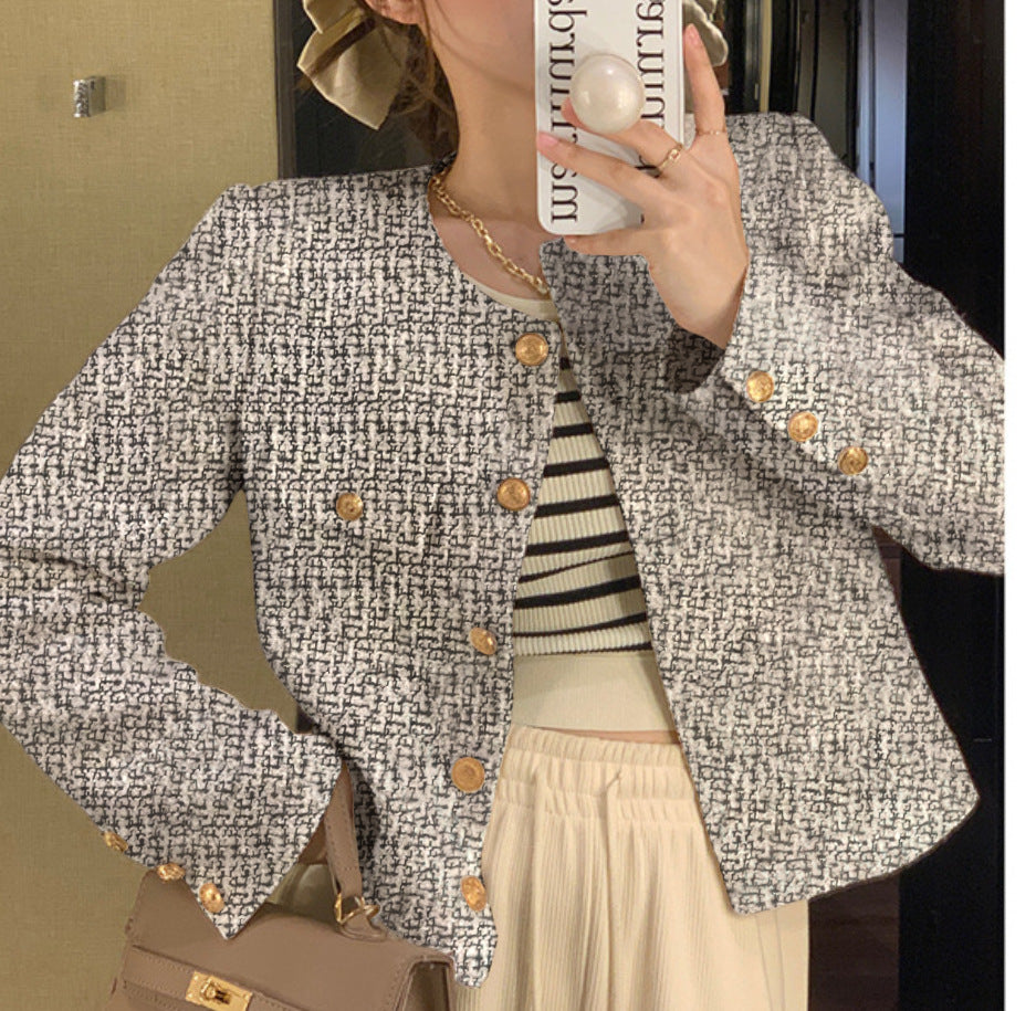 Women's short blazer with elegant gold buttons and modern cut
