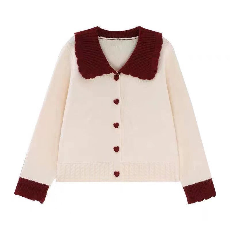 Knitted women's jacket with heart-shaped buttons and a distinctive ruffle collar Lune London