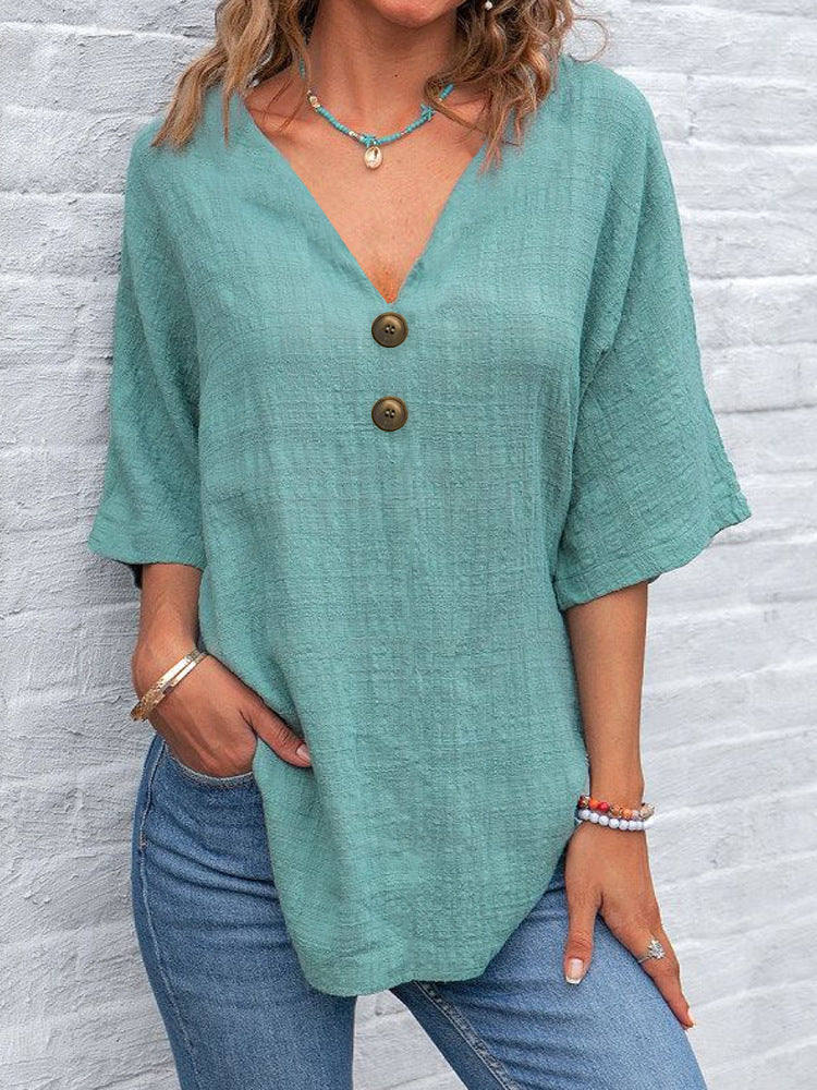 Ladies' V-neck blouse with decorative buttons and chic casual cut