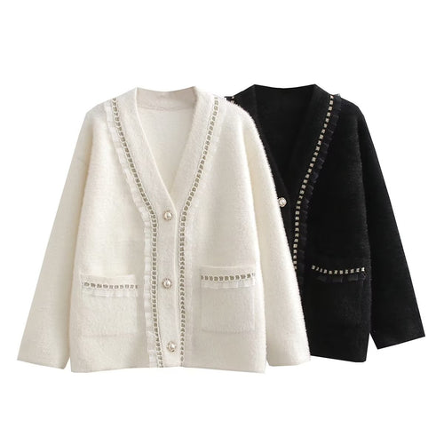 Fashionable women's knitted jacket with decorative ruffles and button details adorned with pearls Lune London