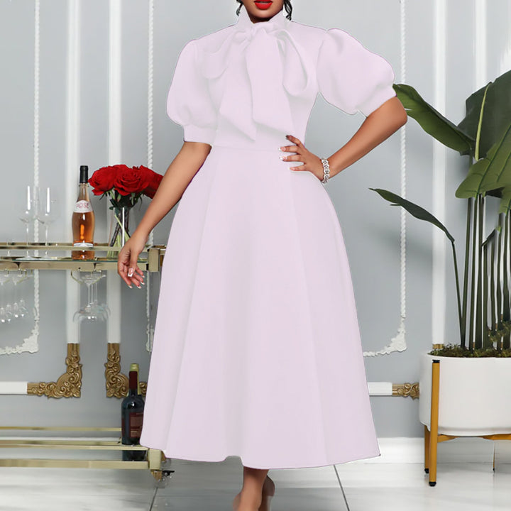 Elegant maxi dress for women with voluminous puff sleeves and a bow neckline Lune London