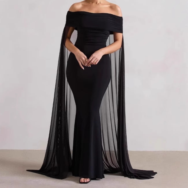 Elegant evening dress for women with off-the-shoulder design, flowing sheer cape, and flattering cut Lune London