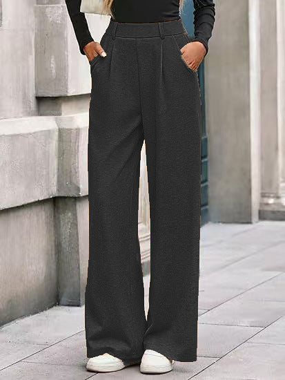 Loose fabric trousers for women with high waist and practical pockets. Chic and style