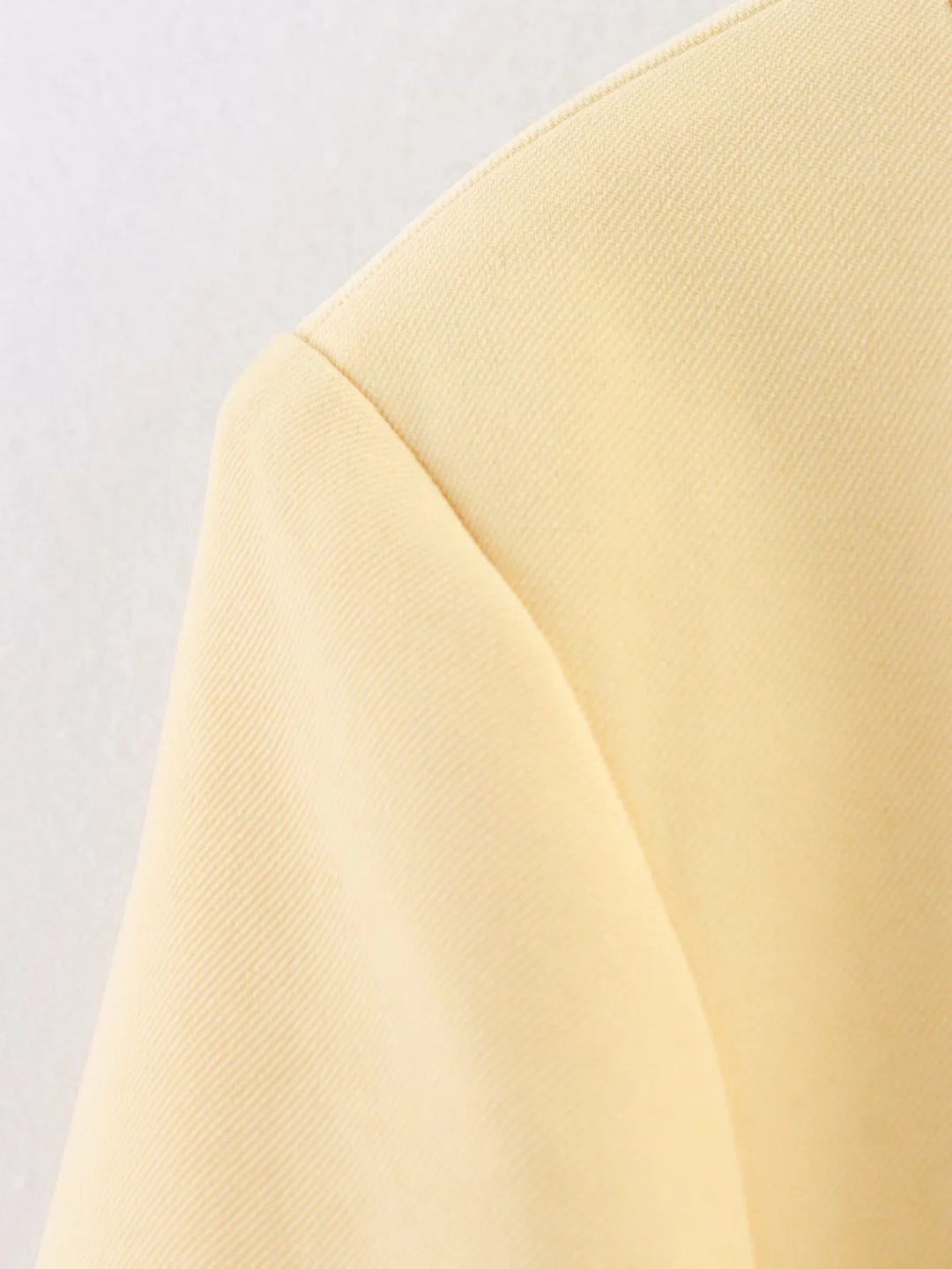 Elegant short blazer for women with a tailored fit and chic button details.