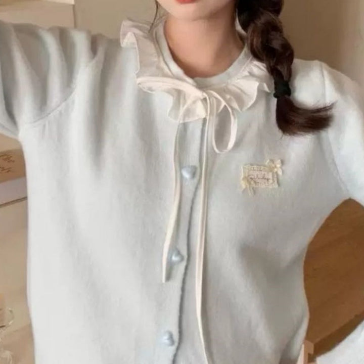 Ladies playful cardigan with ruffle detail and pearl-like buttons Lune London