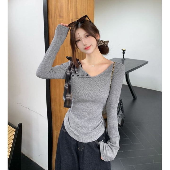 Women’s long sleeve top with modern asymmetric neckline and decorative button details Chic & Stil