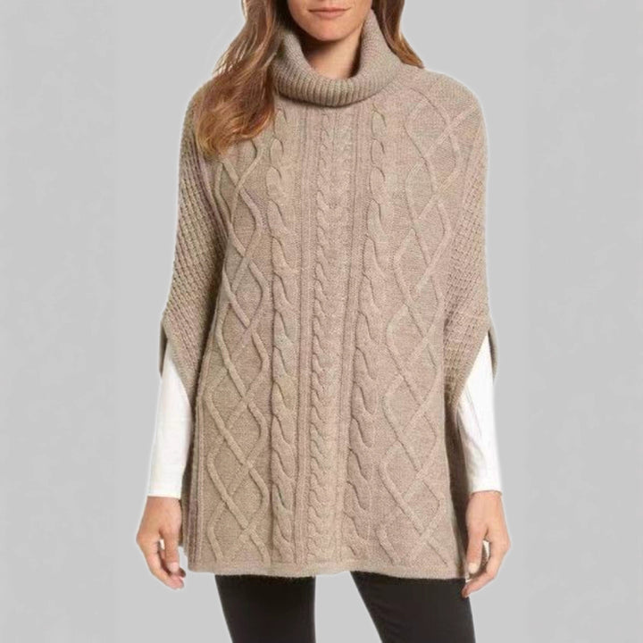 Knitted poncho for women with high collar and classic cable knit pattern Lune London