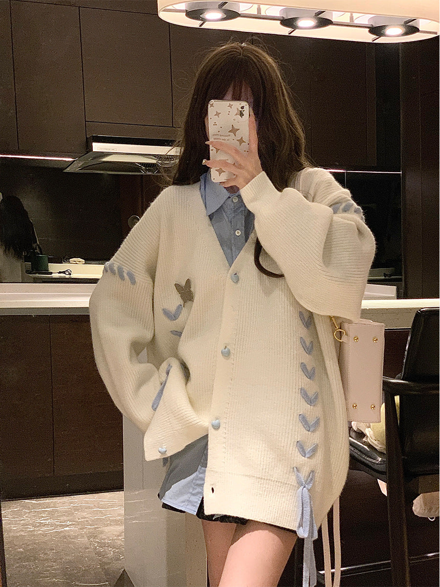 Ladies knit vest with playful heart-shaped details and a chic bow