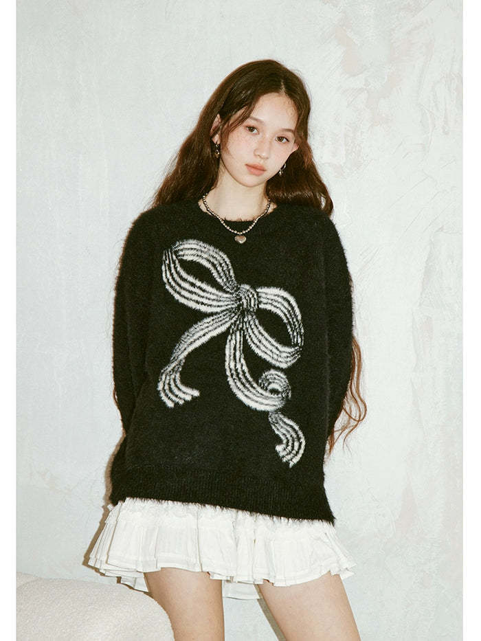 Pull femme avec motif nœud ludique et matière douce Chic & Stil