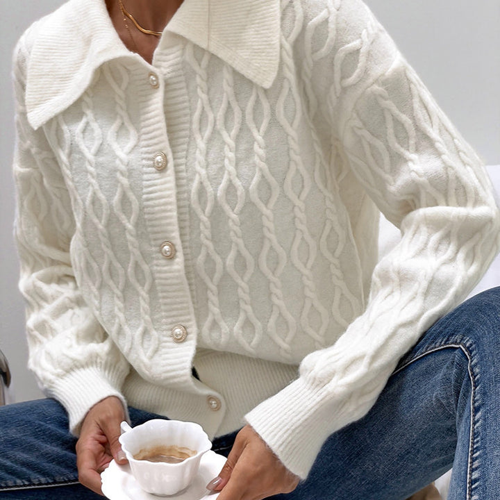 Ladies chunky sweater with an elegant cable knit pattern and chic pearl buttons