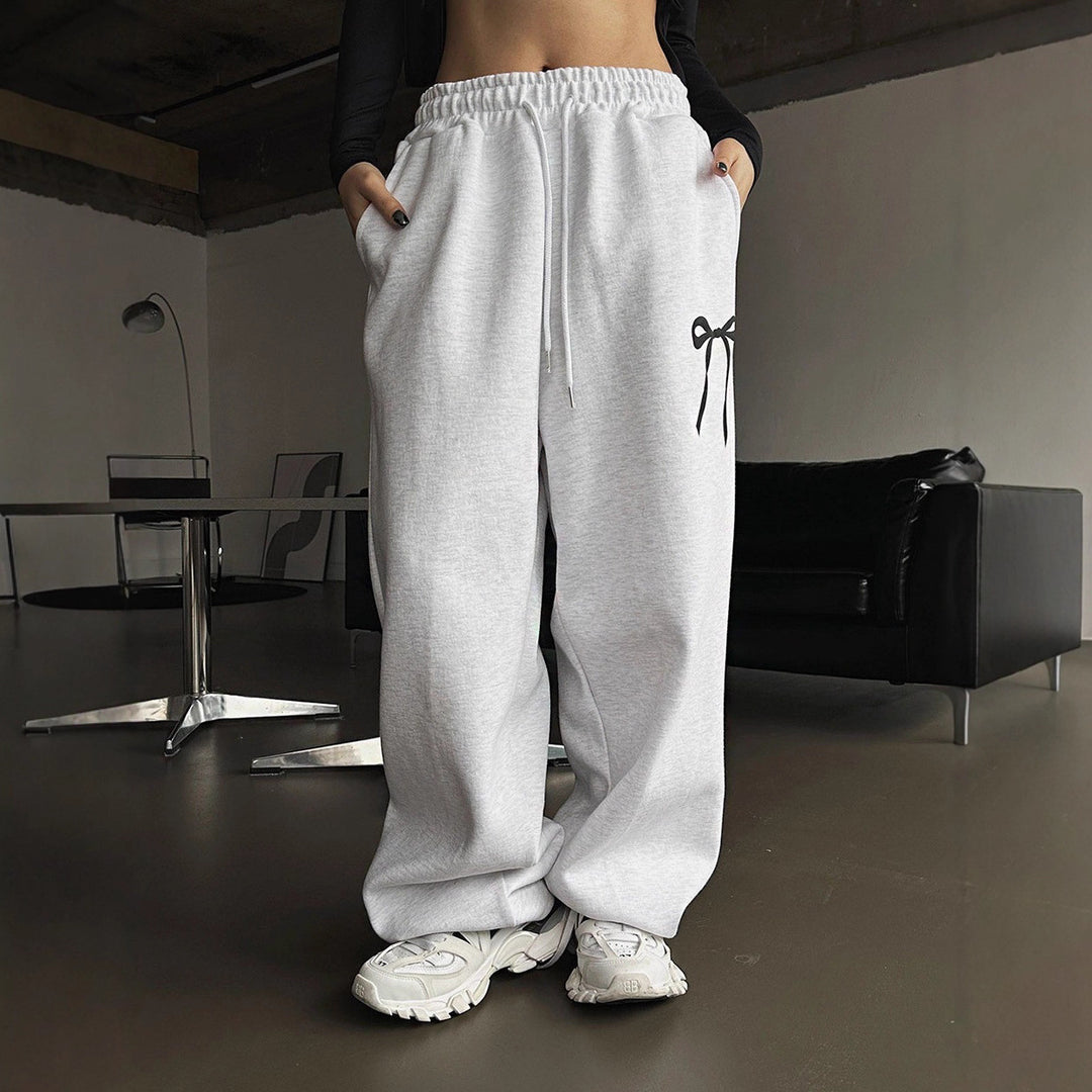 Women's loose leisure pants with elastic waistband and decorative bow motif Chic & Stil