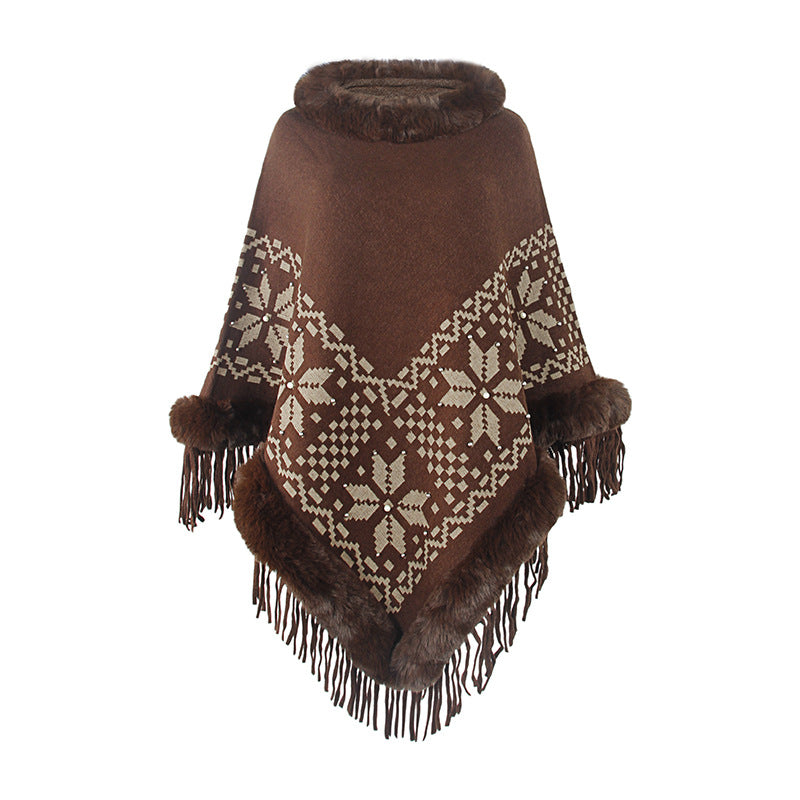 Elegant women's poncho with decorative fringe design and faux fur trim Lune London