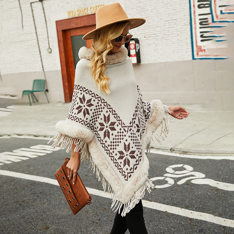 Elegant women's poncho with decorative fringe design and faux fur trim Lune London