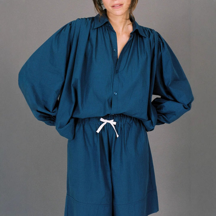 Woman casual outfit combined with loose blouse and shorts Lune London
