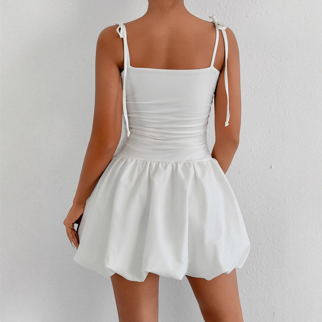 Women's playful mini dress with adjustable spaghetti straps and sophisticated ruffle hem Lune London