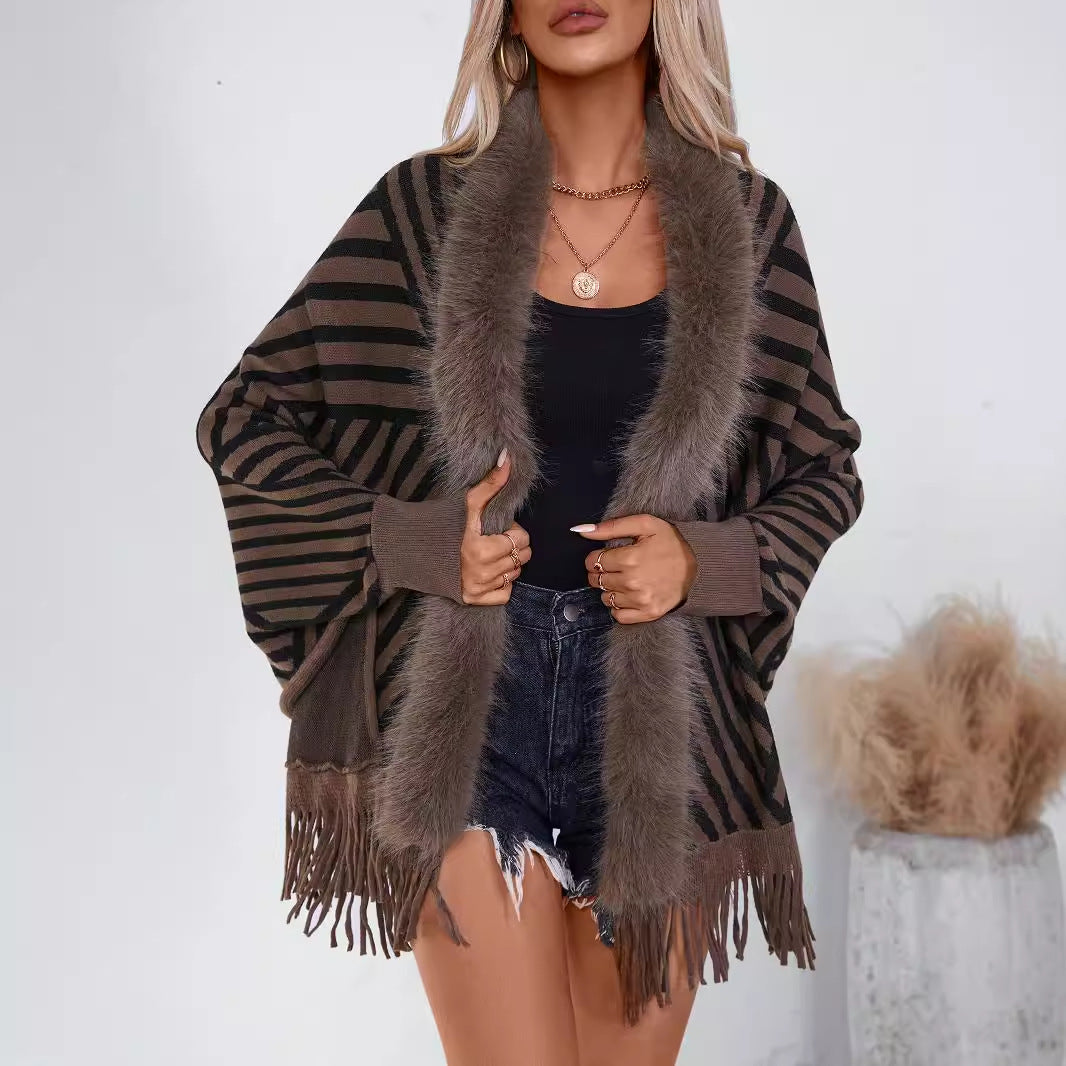 Ladies knitted poncho with elegant faux fur collar and fringe design Lune London