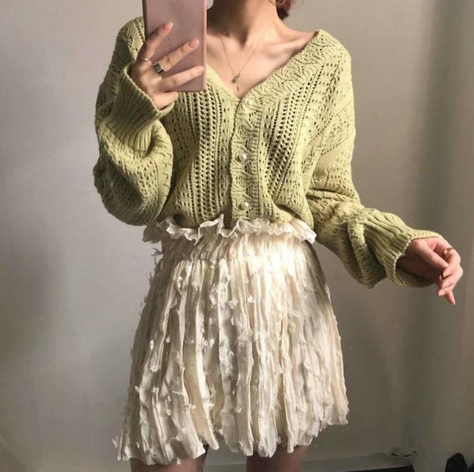 Thick knitted sweater for women with a trendy V-neck and chic button details
