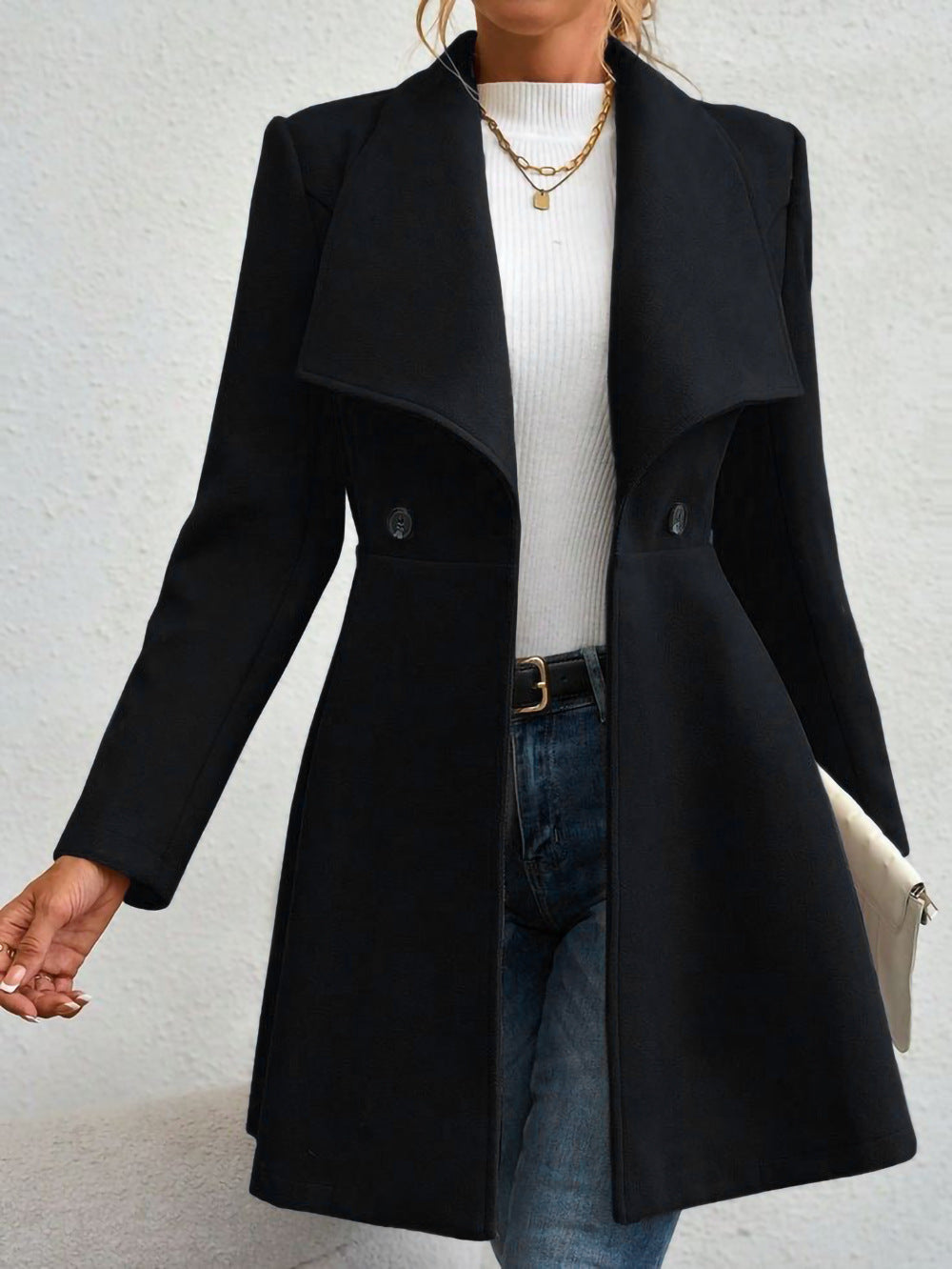 Ladies elegant wool coat with a loose and cinched silhouette and modern button details Lune London