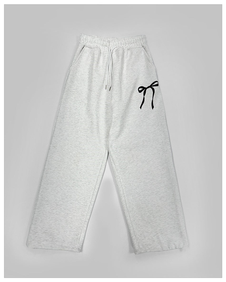 Women's loose leisure pants with elastic waistband and decorative bow motif Chic & Stil