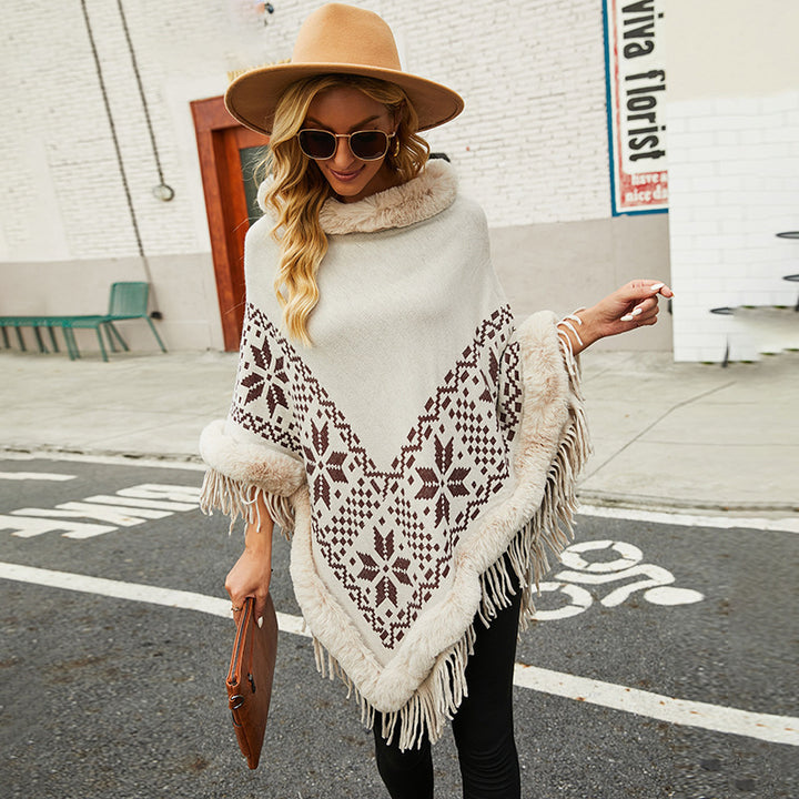 Elegant women's poncho with decorative fringe design and faux fur trim Lune London