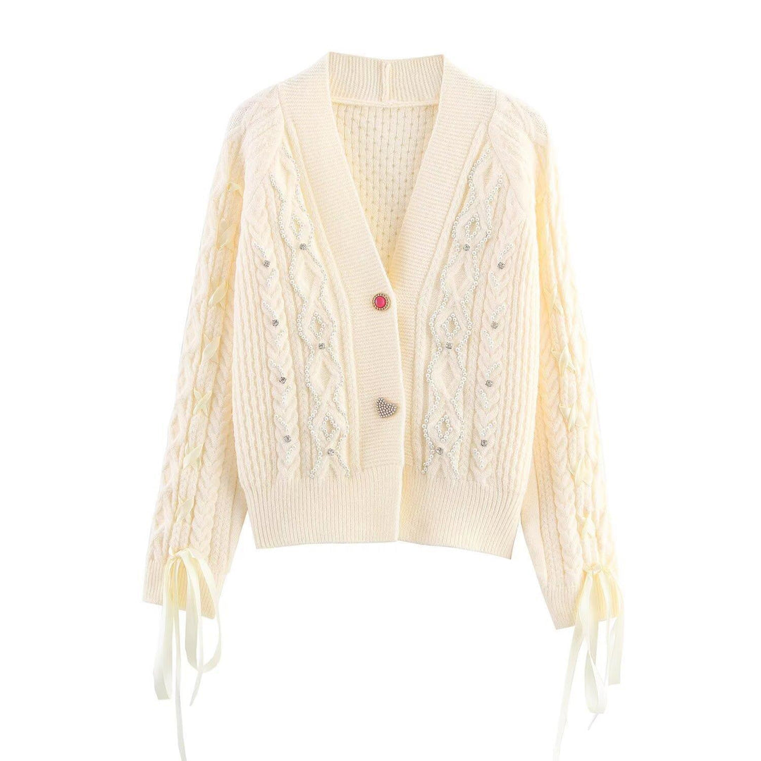 Elegant women's cardigan with decorative buttons and ruffle details Lune London