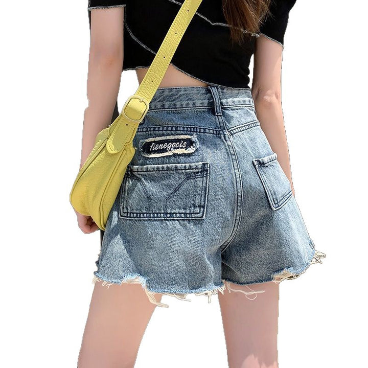 Women's denim shorts with frayed hems and unique embroidery detail Lune London