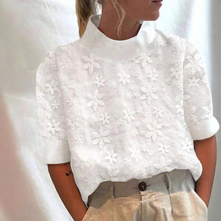 Blouse femme avec design de broderie florale et coupe courte Chic & Stil