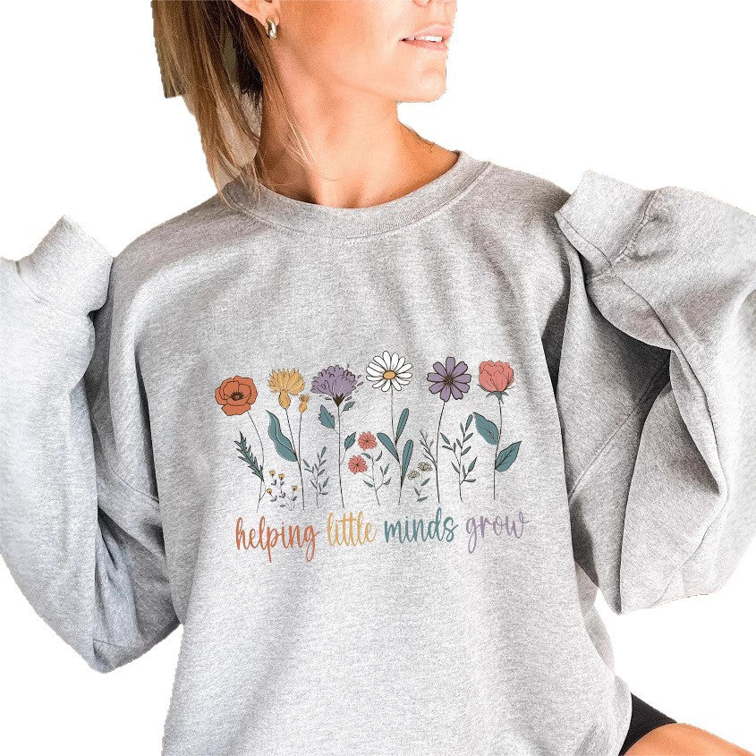Sweat-shirt femme avec des manches volumineuses et un imprimé floral motivant Chic & Stil