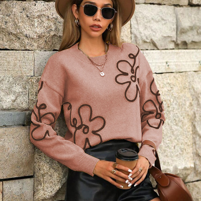 Pull féminin à la mode avec des appliqués floraux Chic & Stil